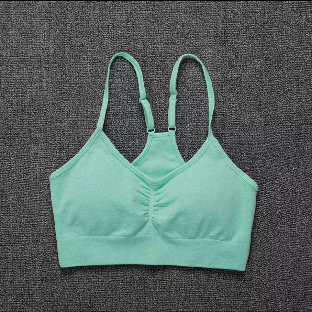 Turquoise brand new sports bra with pads.